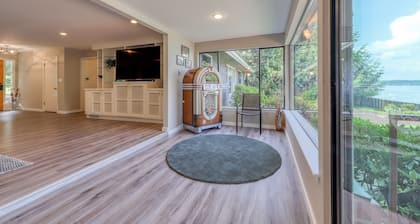 Waterfront home & on-site guest house w/ full kitchens, a large deck, & firepits