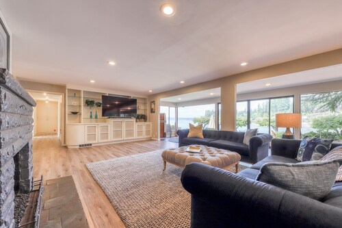 Waterfront home & on-site guest house w/ full kitchens, a large deck, & firepits