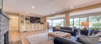 Waterfront home & on-site guest house w/ full kitchens, a large deck, & firepits