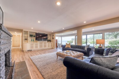 Waterfront home & on-site guest house w/ full kitchens, a large deck, & firepits