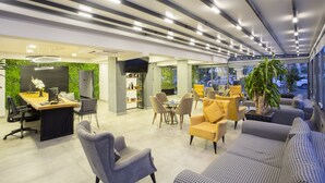 A modern office space with a reception area, meeting tables, and comfortable seating. - Falcon 1511 (Antalya)