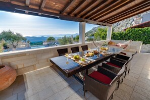 Outdoor dining - VILLA RUNJE- STONE BEAUTY with heated pool, jacuzzi, amazing view on Split & sea (Gornje Sitno)