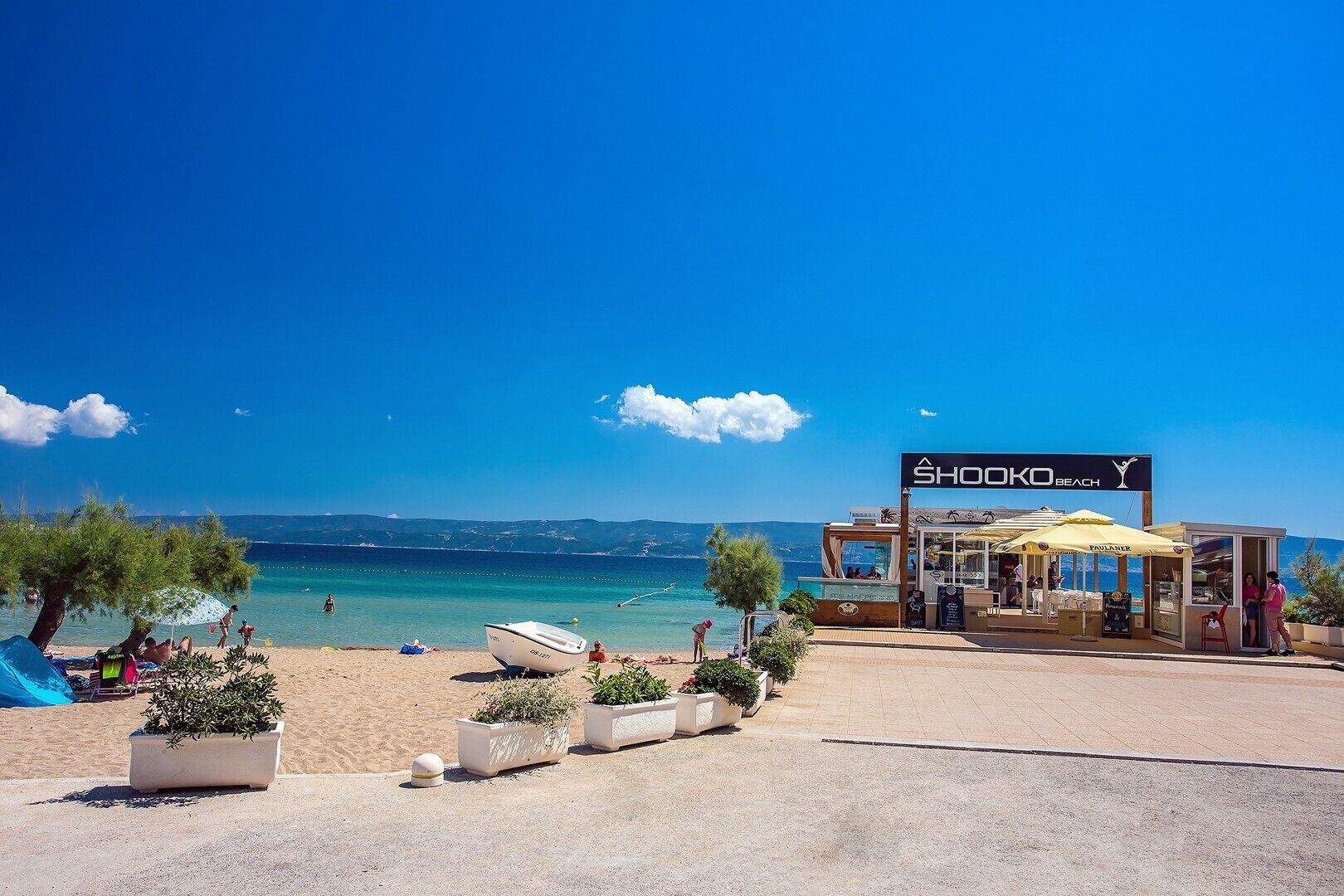 A beachside restaurant named 'Shoko Beach' with outdoor seating and a view of the sea.