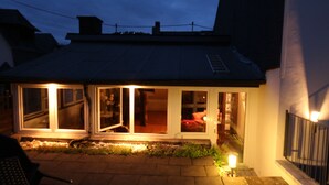 A house with a covered porch and a small garden area. - ......... Your vacation home to relax, enjoy and relax. (Zell (Mosel))