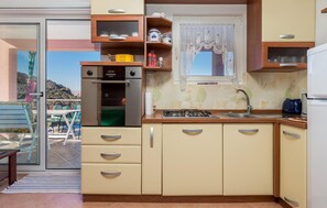 Fridge, stovetop, coffee/tea maker, cookware/dishes/utensils