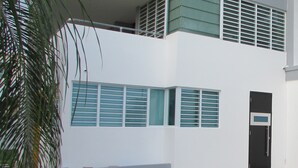 A modern building with a flat roof, a balcony, and a door with a keypad lock. - Perfect for relax time (La Parguera)