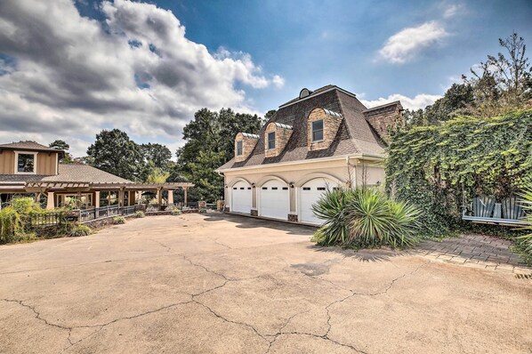 A large house with a garage, a covered patio, and a driveway.