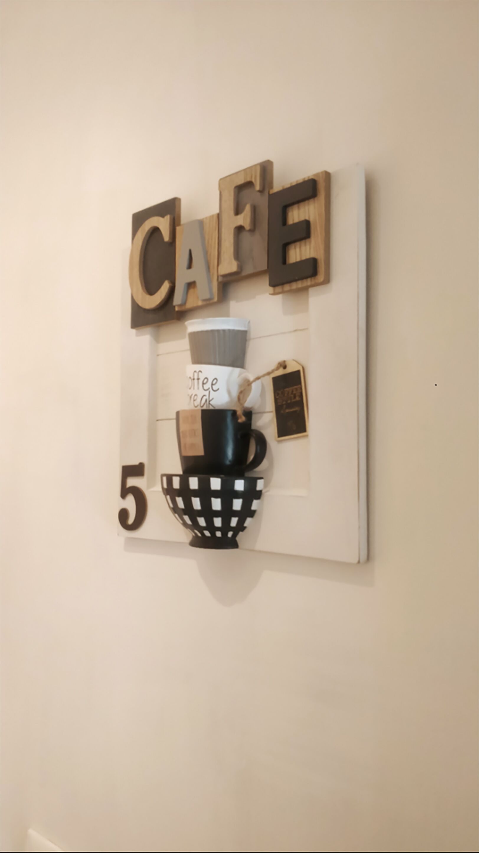 A wall-mounted decor piece with the word "CAFE" and a number "5".