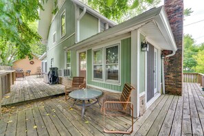 Enjoy a peaceful moment on the deck with a comfortable seating area featuring two chairs and a table.