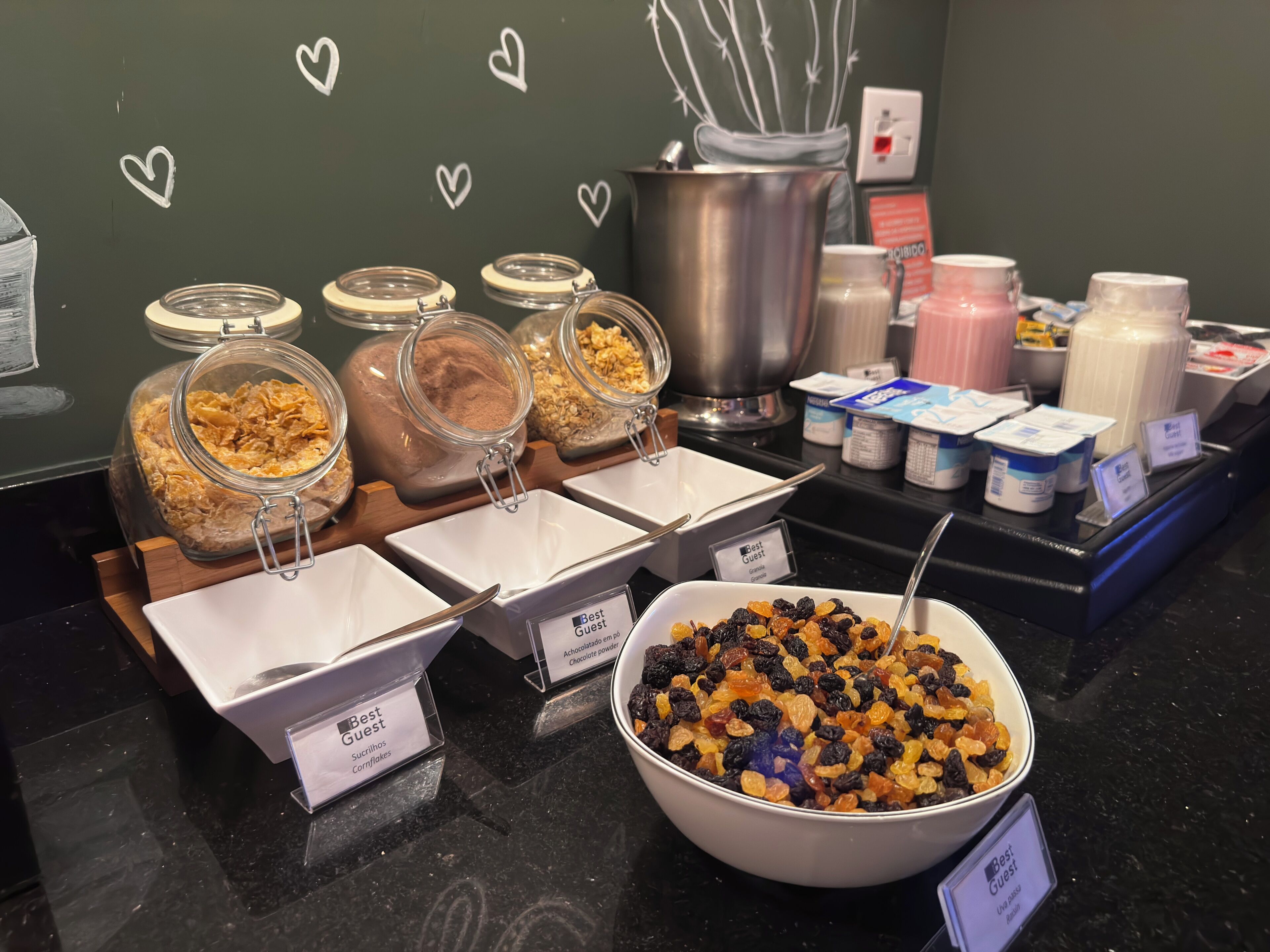 A buffet with various food items and containers labeled "Best Guest."