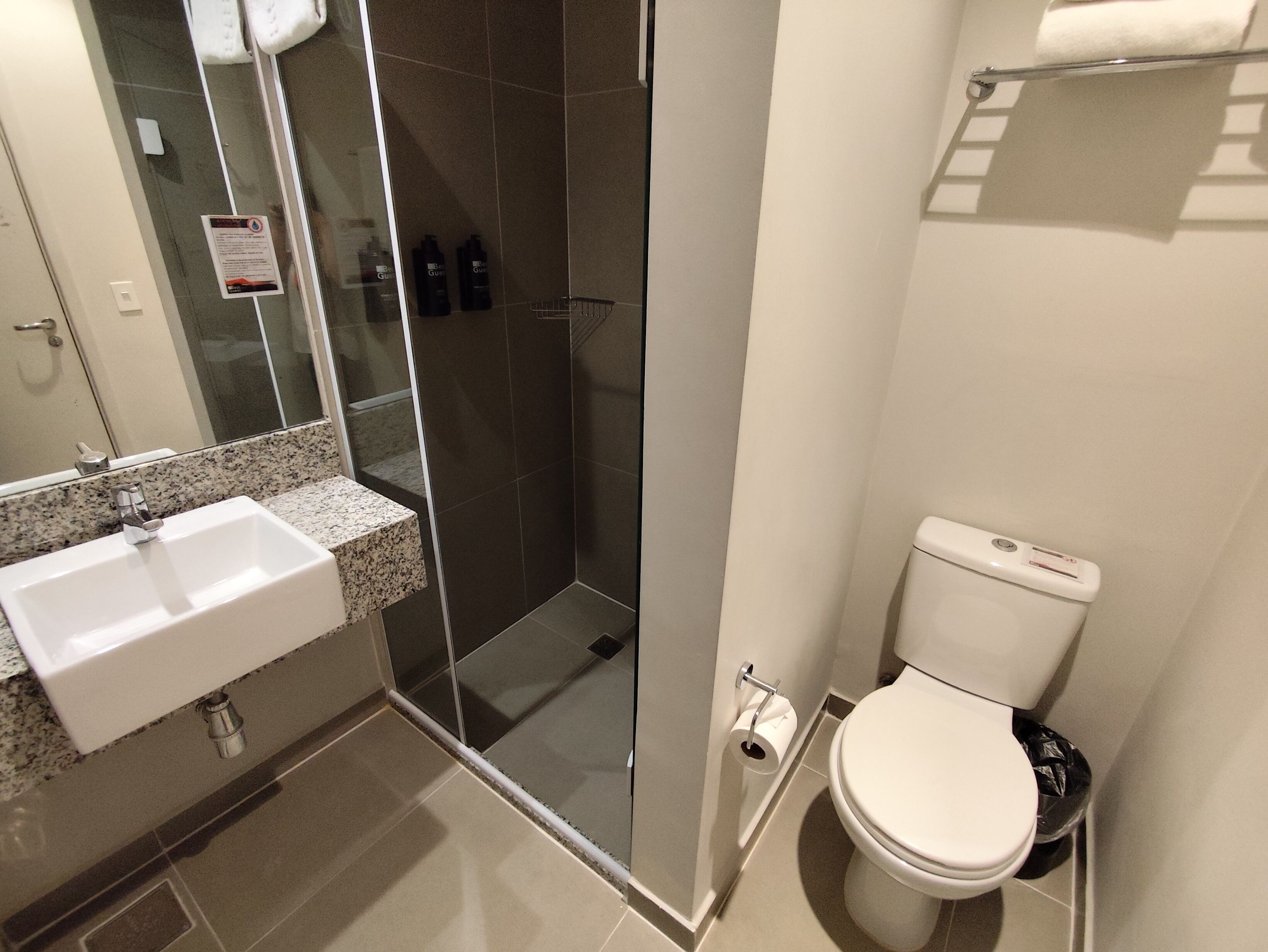 A bathroom with a sink, toilet, and shower.