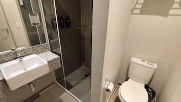 A bathroom with a sink, toilet, and shower.