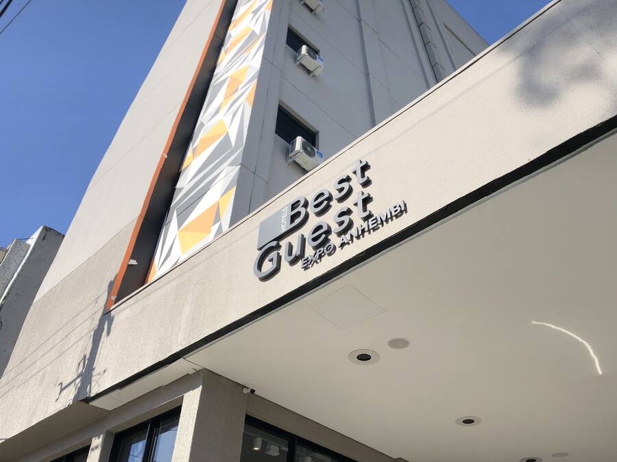 Hotel con diseño moderno, destacando un letrero con los nombres 'Best' y 'EXPO HEMBI'.