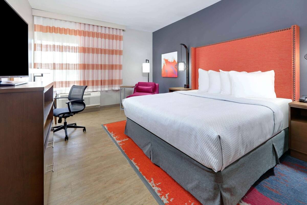 Desk, laptop workspace, iron/ironing board, bed sheets