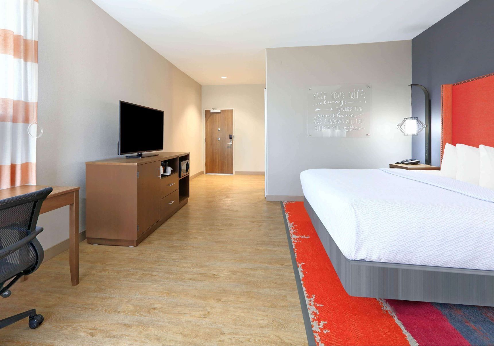 Desk, laptop workspace, iron/ironing board, bed sheets