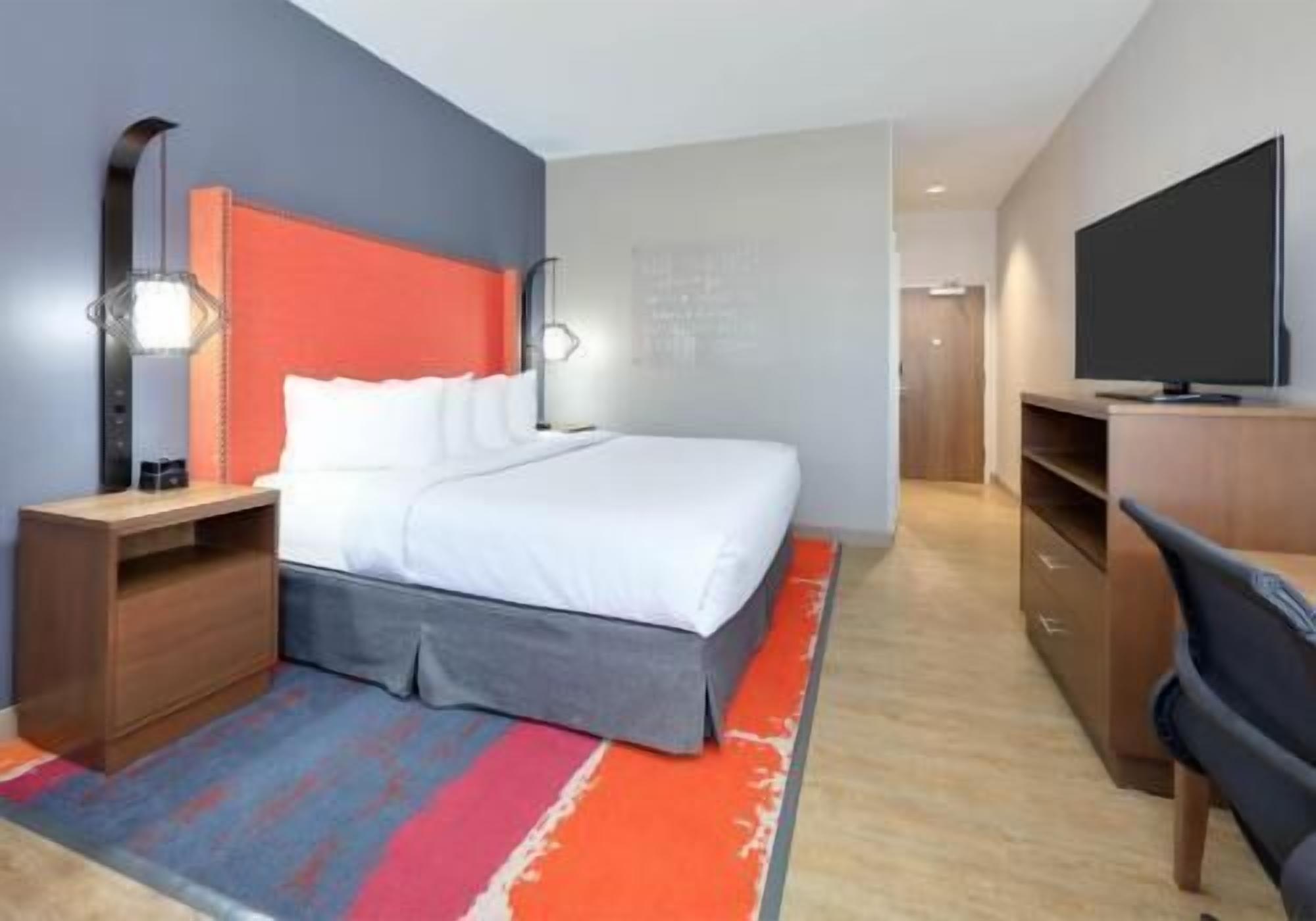 Desk, laptop workspace, iron/ironing board, bed sheets