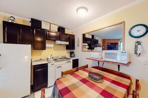Enjoy cooking in this well-equipped kitchen with a stove, microwave, and sink.