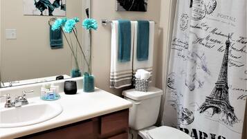 Combined shower/tub, hair dryer, towels, soap
