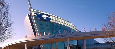 A modern building with a large glass facade and a prominent 'X' logo.