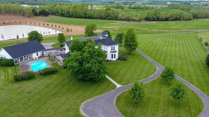 A large house with a swimming pool, surrounded by well-maintained lawns and a winding driveway. - Wildflower Ranch Inn (Springfield)