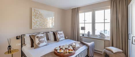 Une chambre à coucher avec un lit, une table de chevet, une fenêtre et une vue sur la ville.