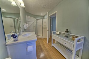 A bathroom with a large sink, mirror, and a walk-in shower. - A Block Away Bliss: Steps from Seaside & Sand! (Santa Rosa Beach)