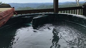 A hot tub with a view of mountains. - Breath Taking View of the Highlands of the Roan with Hot Tub and Pool Table (Roan Mountain)