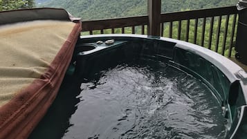 A hot tub with a view of mountains.