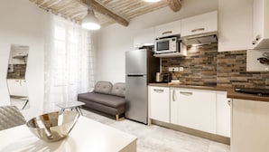 A modern kitchen with white cabinets, a built-in microwave, and a stainless steel refrigerator. - Great brand new 1 bedroom apartment in the center of old Antibes (Antibes)