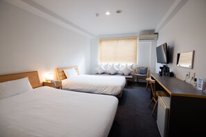 A hotel room with two beds, a desk, a chair, a TV, and a window with blinds. - You Style Hotel Marine (Kagoshima)