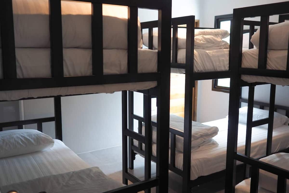 A bunk bed room with a table and a remote control.