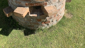 A brick structure with a frog statue on top. - House with winter garden and patio (Burgheim)