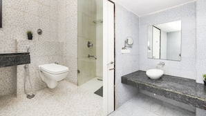A bathroom with a toilet, shower, and sink. - Treebo Tryst F One (Hyderabad)