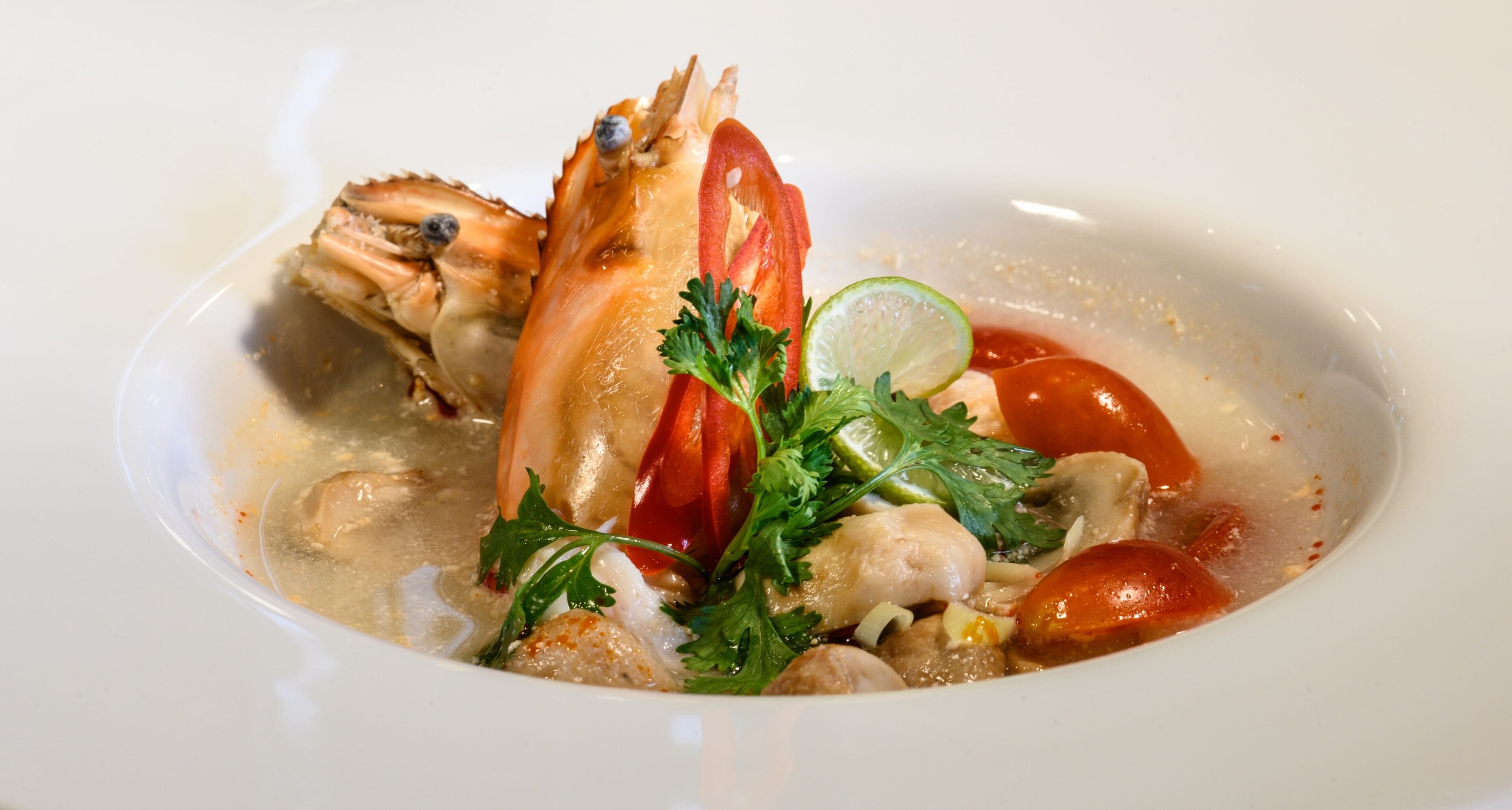 A seafood dish with crab, tomatoes, and herbs.