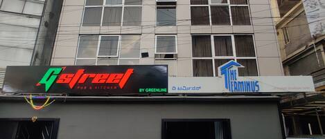 A multi-story building with signage for 'Green Street Pub & Kitchen' and 'The Terminus Boutique Hotel'.