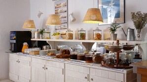 A breakfast buffet with various food items, glass jars, and a coffee machine. - Albatros Club Mykonos (Mykonos)