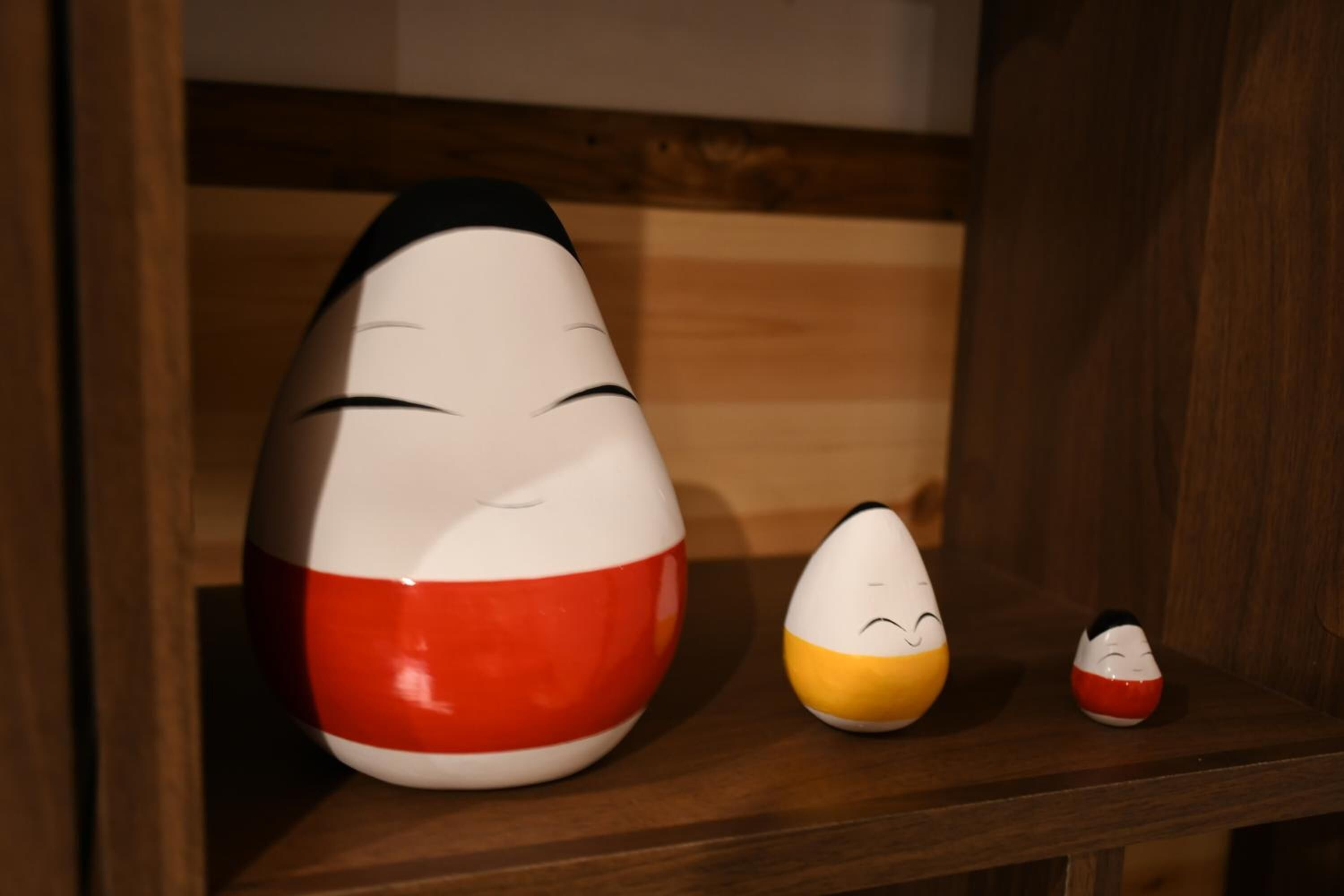 A shelf with three ceramic figures.