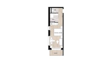 A floor plan of a hotel room with a balcony, a WC, a kitchen area, and a living room.