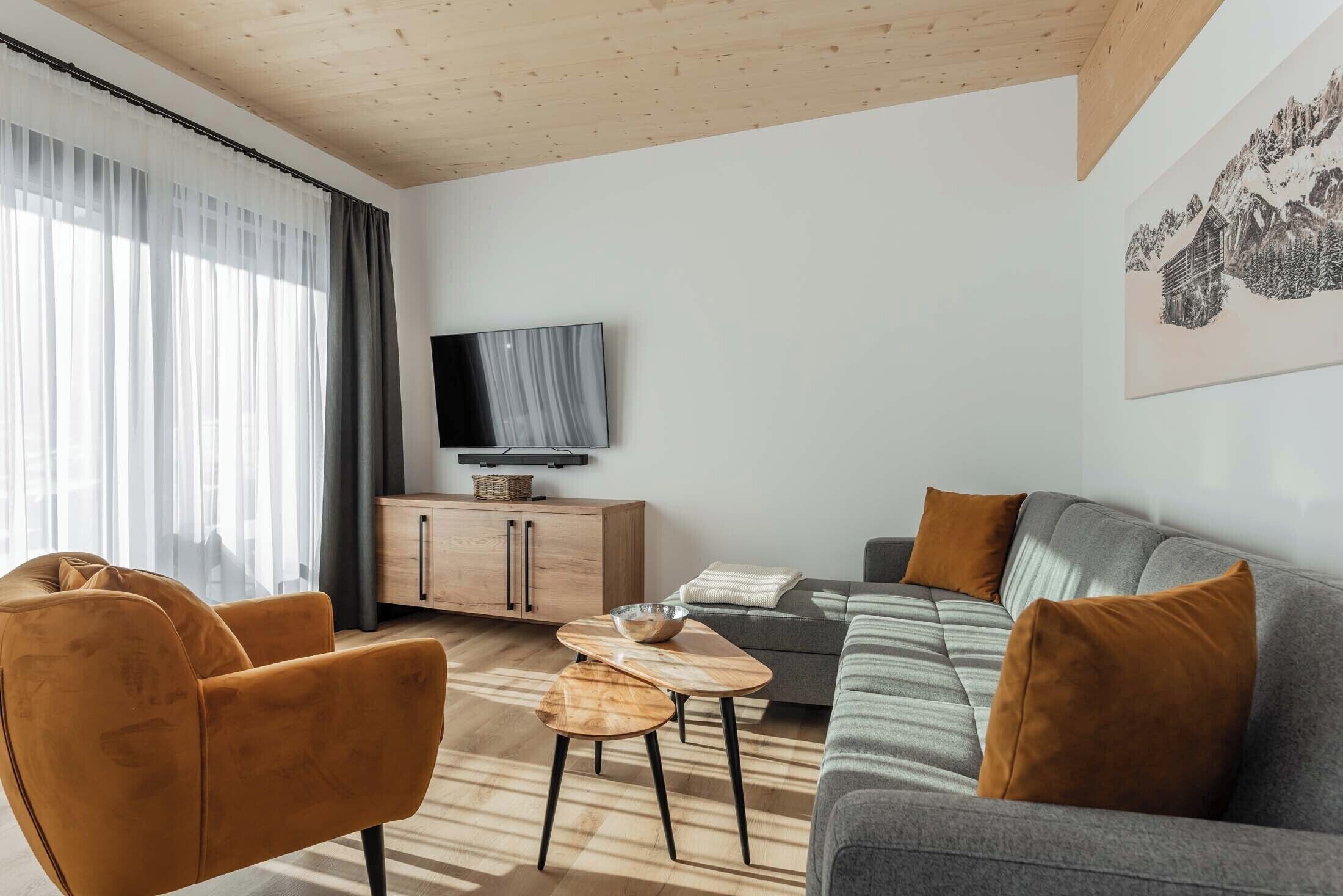 Een moderne woonkamer met een bank, fauteuil en salontafel.