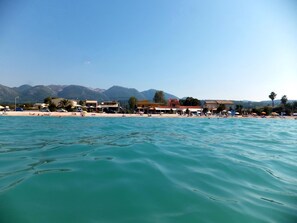 On the beach, sun-loungers, beach bar