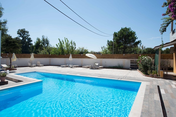 Seasonal outdoor pool, open 10:30 AM to 6:30 PM, pool umbrellas