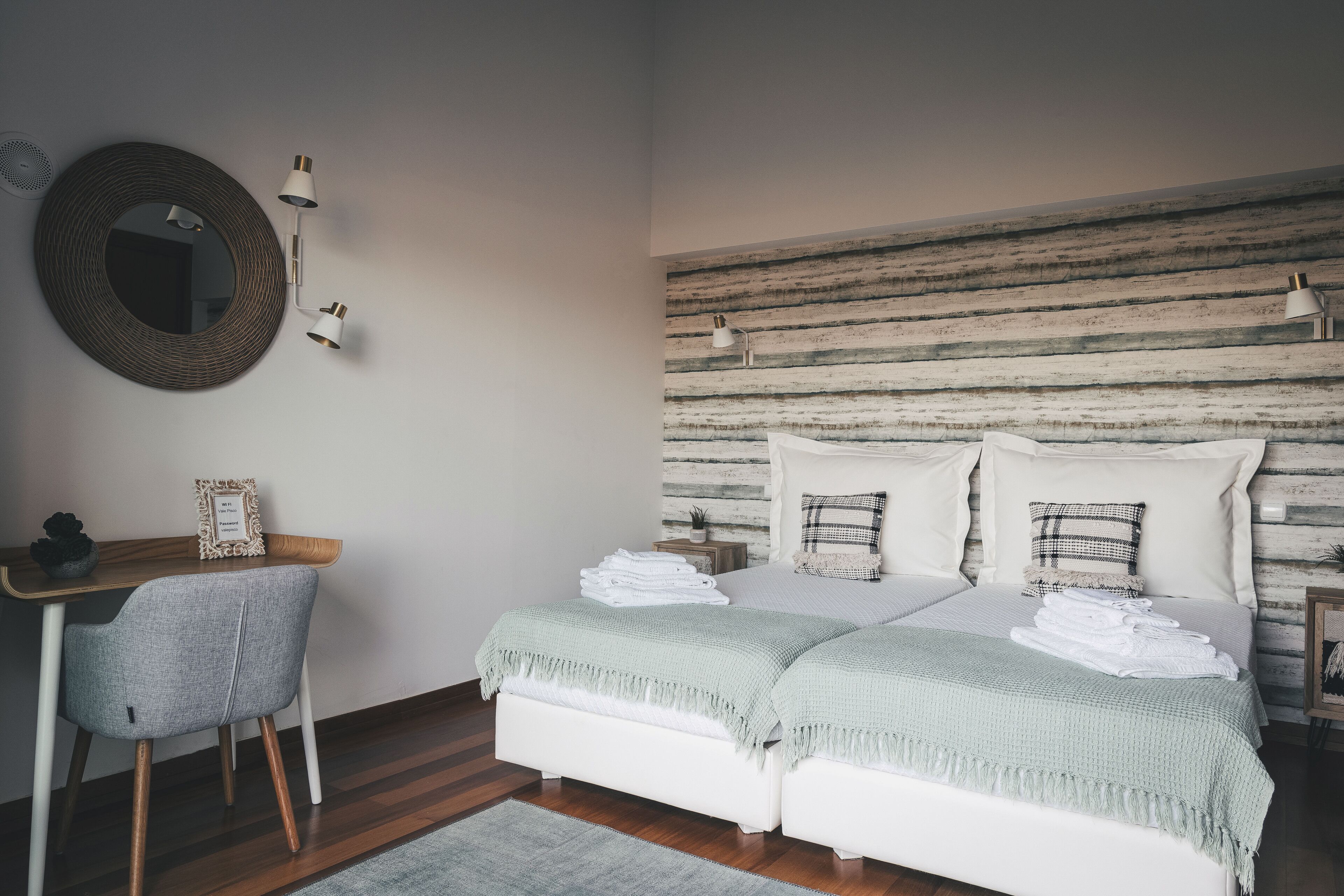 A bedroom with a bed, a desk, and a chair.