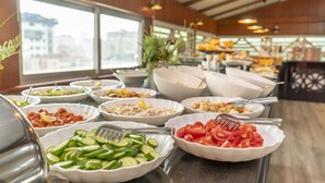 A buffet with various dishes including cucumbers, tomatoes, and other salads. - The Bostanci Hotel (Istanbul)