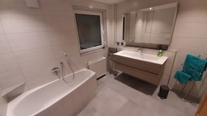 Bathtub, hair dryer, towels, soap