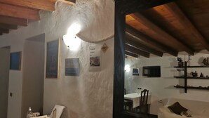 A room with a wooden ceiling, a mirror, a desk with a laptop, a bottle of hand sanitizer, and a chair. - Villa Cecilio (Puerto del Rosario)