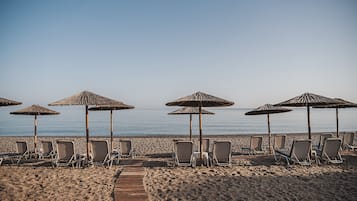 On the beach, sun-loungers, beach umbrellas, beach towels