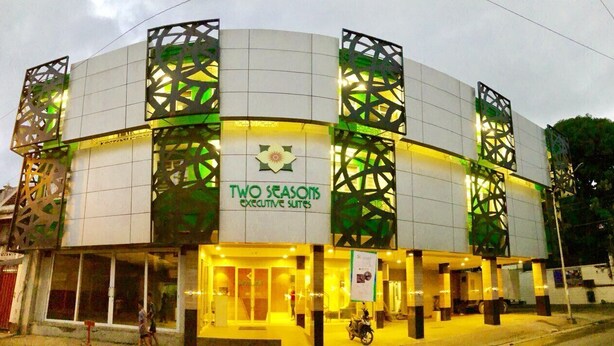 A hotel with a modern design, featuring a prominent logo and signage for "Two Seasons Executive Suites." - Two Seasons Executive Suites (Zamboanga)