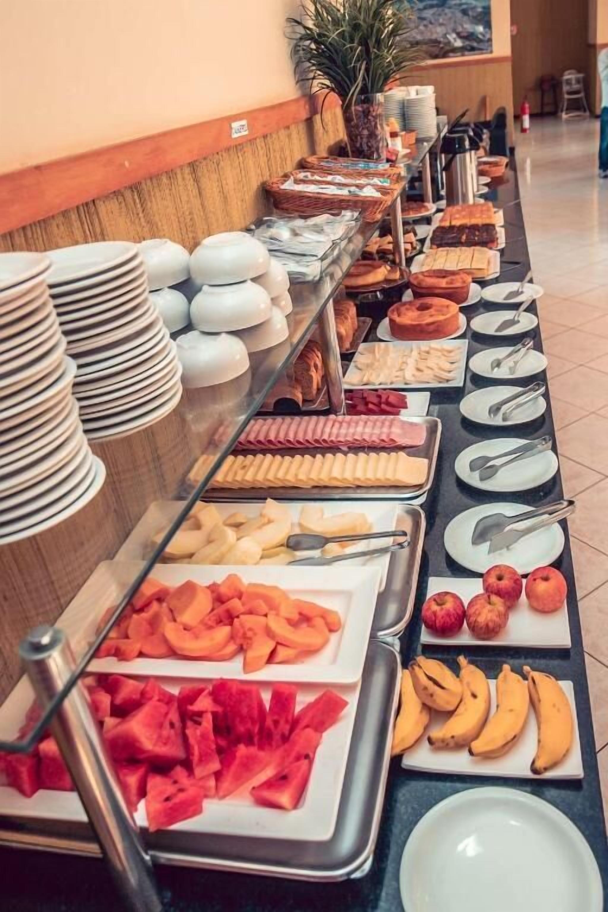 A buffet with various food items and serving utensils.