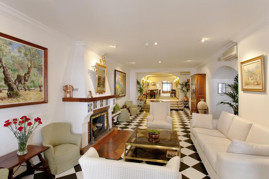 A spacious living room with a checkered floor, a fireplace, and a view of the dining area.