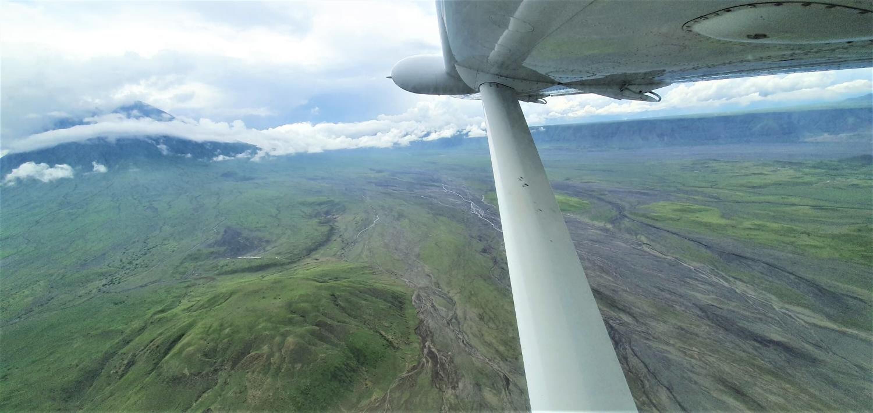 An aerial view of a mountainous landscape with a clear sky.